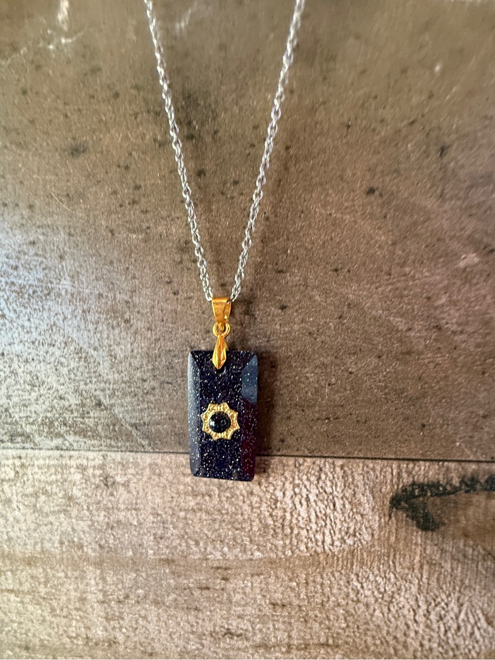 Stainless steel necklace with black gold stone pendant